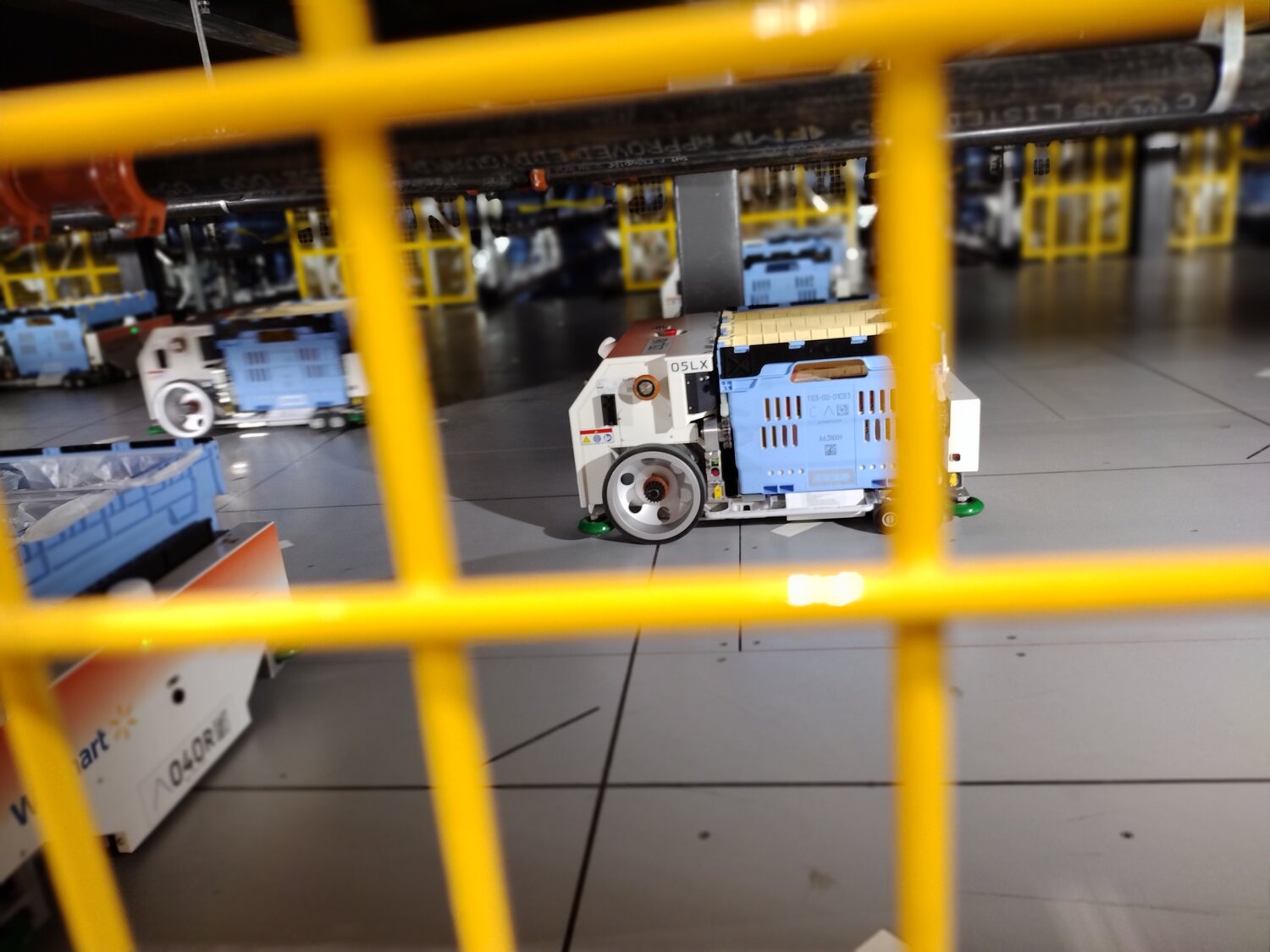 Robots scurry back and forth carrying products to and from storage at Walmart’s Fulfillment Center in Katy. The machines also retrieve items from the storage areas to fulfill customer orders for pick-up.
